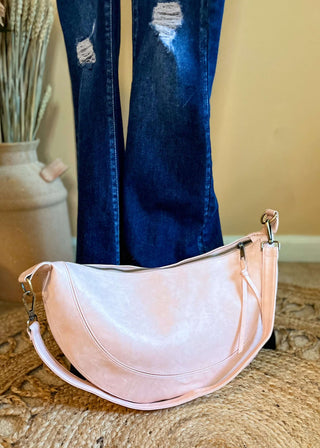 Front view of the Dakota Crescent Crossbody in elegant Blush