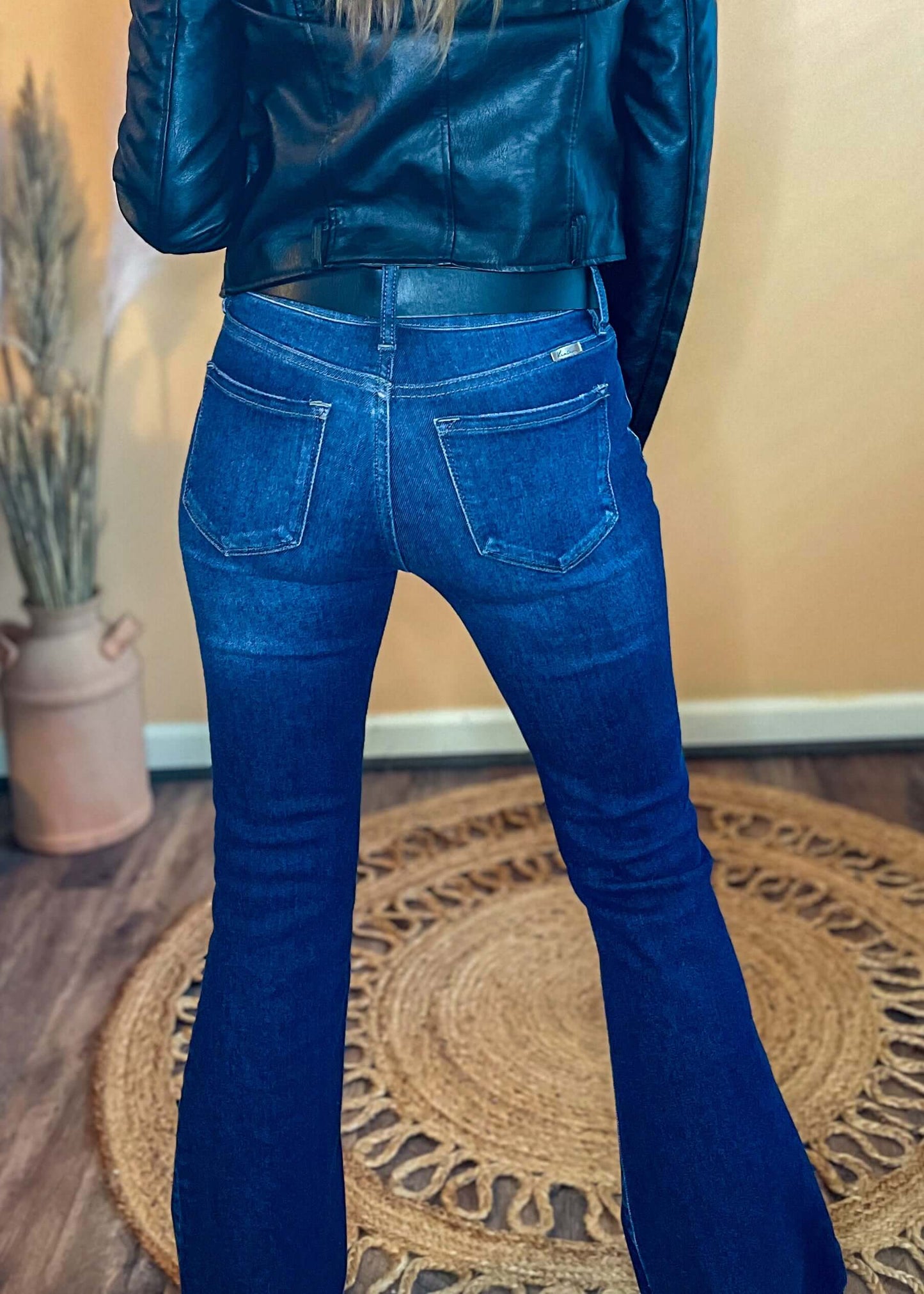 Back view of the jeans, highlighting the fit and flare design from a different angle.
