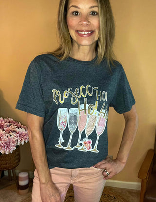 Champagne flutes and gold lettering holiday graphic on dark grey tee