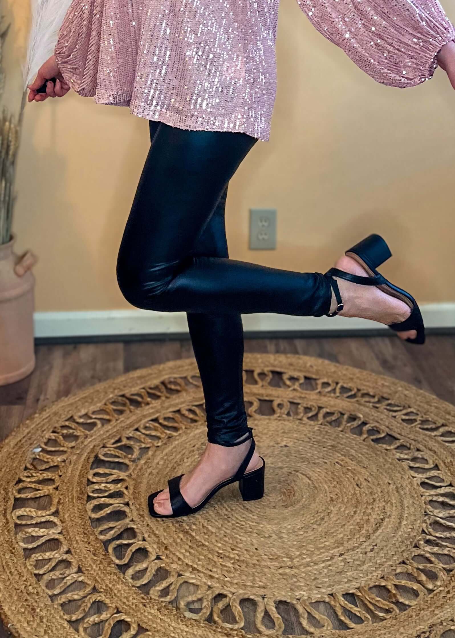 Side view of the leggings, displaying the ankle length and slim fit silhouette.